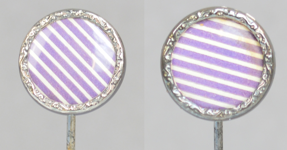 A pair of sterling silver rimmed circular hat pins with purple and white striped centres,