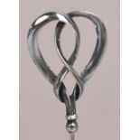 A Charles Horner hallmarked silver hat pin of abstract form with double loop ribbon, Chester 1908,