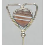 An Edward VII hallmarked silver hat pin in the form of a silver wire triangular heart frame