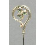 A George V hallmarked silver hat on trefoil floral form within a crook shaped surround,
