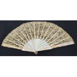 A late 19th century folding fan with mother of pearl guards and sticks with pierced bone slips,