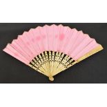 A 19th century folding fan, the bone guards and sticks with pierced decoration,