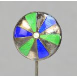 A sterling silver hat pin of circular form with spokes of green and blue enamel radiating from the