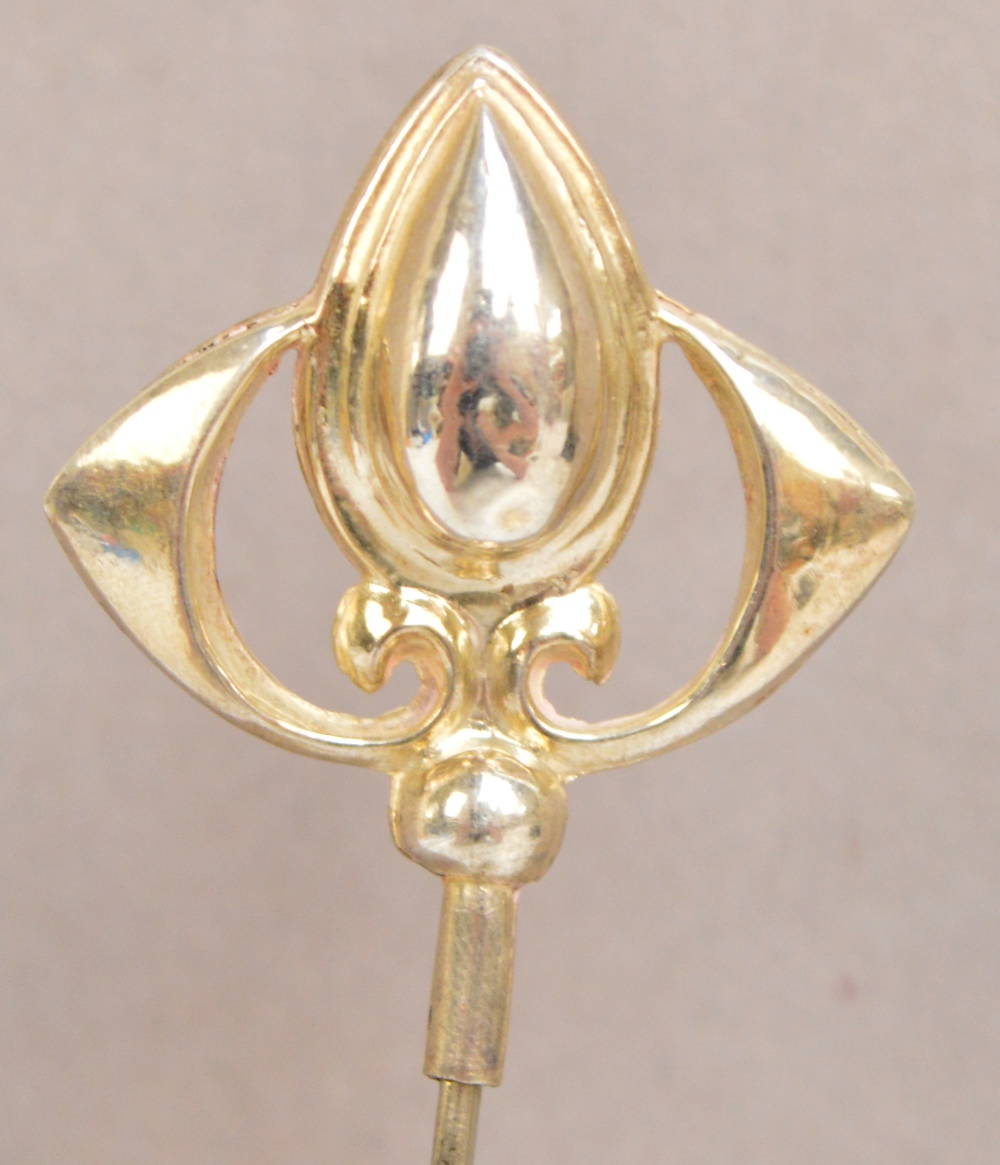 A George V hallmarked silver hat pin of pear shaped form with wings to either side,