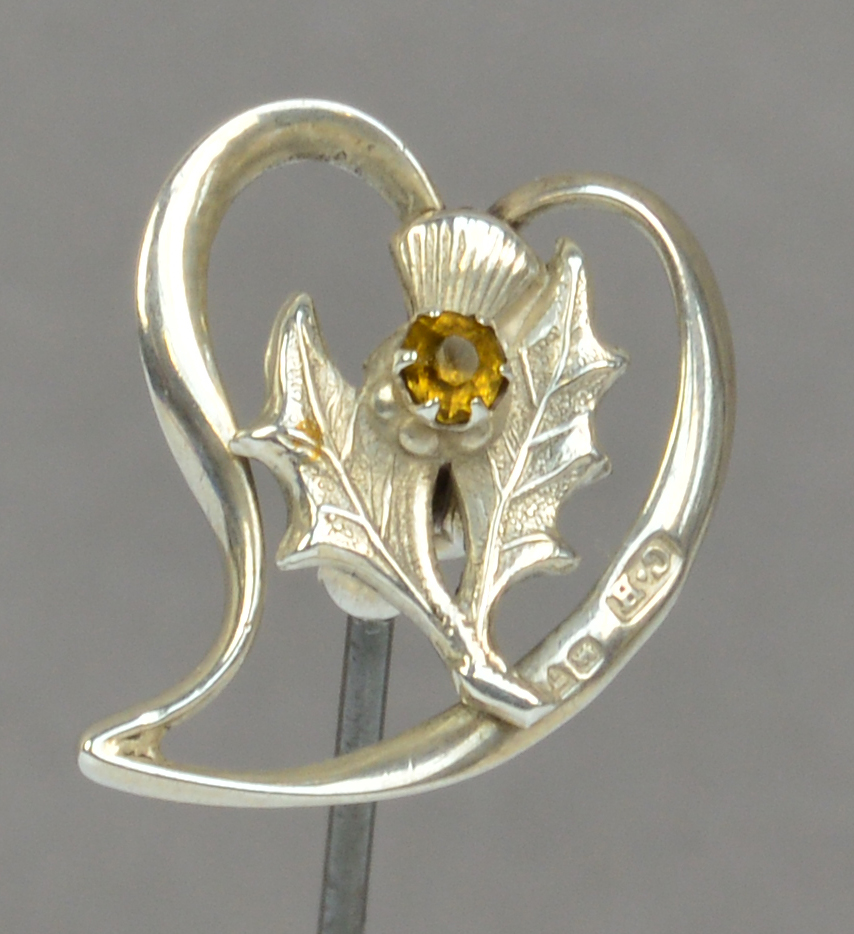 A Charles Horner hallmarked silver hat pin in the form of a thistle set with a citrine coloured