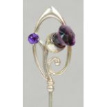 A Charles Horner hallmarked silver hat pin in the form of an amethyst coloured glass thistle and