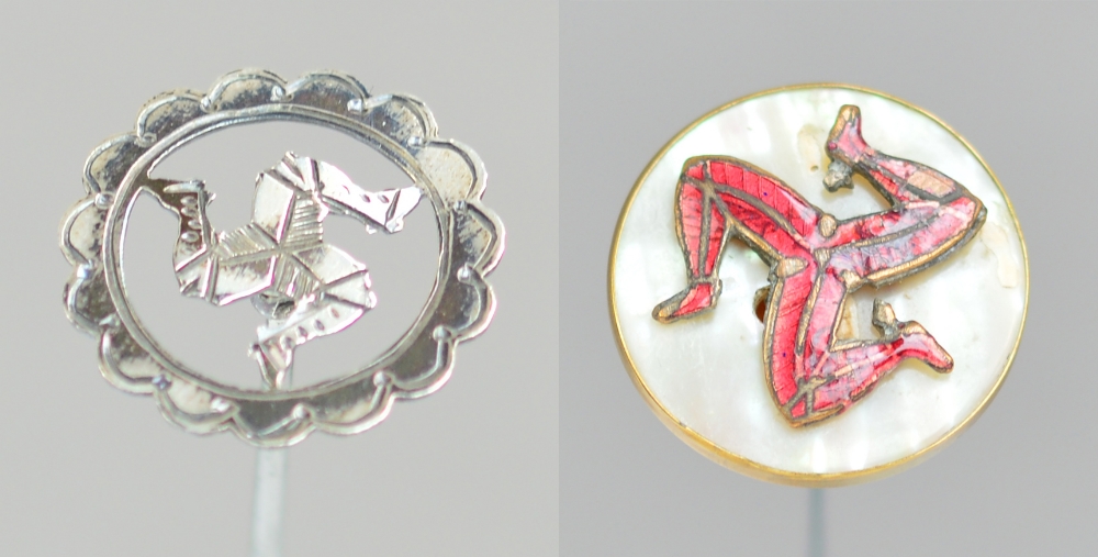 A George V hallmarked silver circular hat pin decorated with a bright cut three legged emblem of