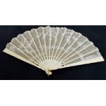A late 19th century folding fan with carved bone guards and matching sticks,