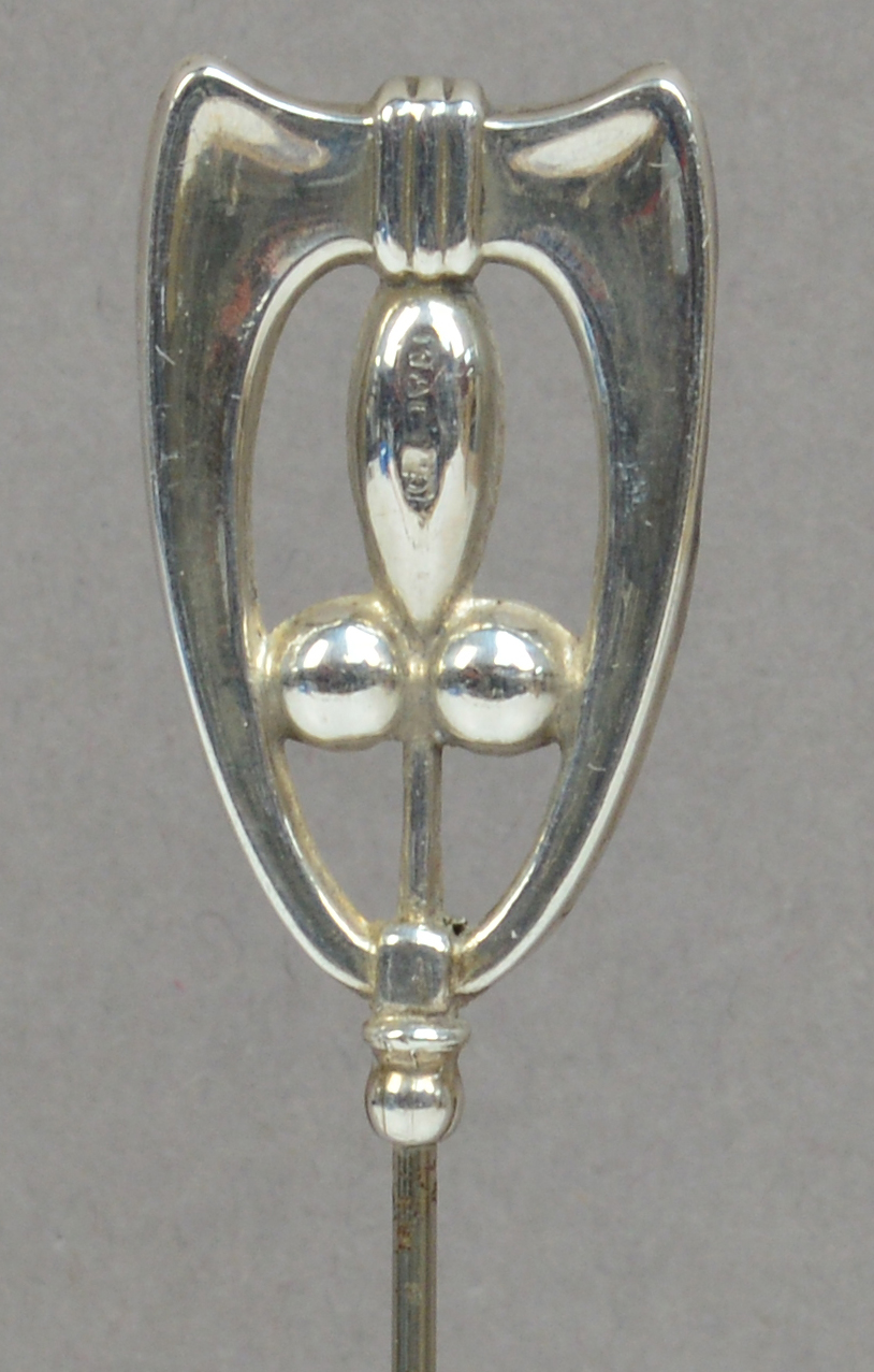 A Charles Horner hallmarked silver hat pin of abstract form with a geometric pattern within a