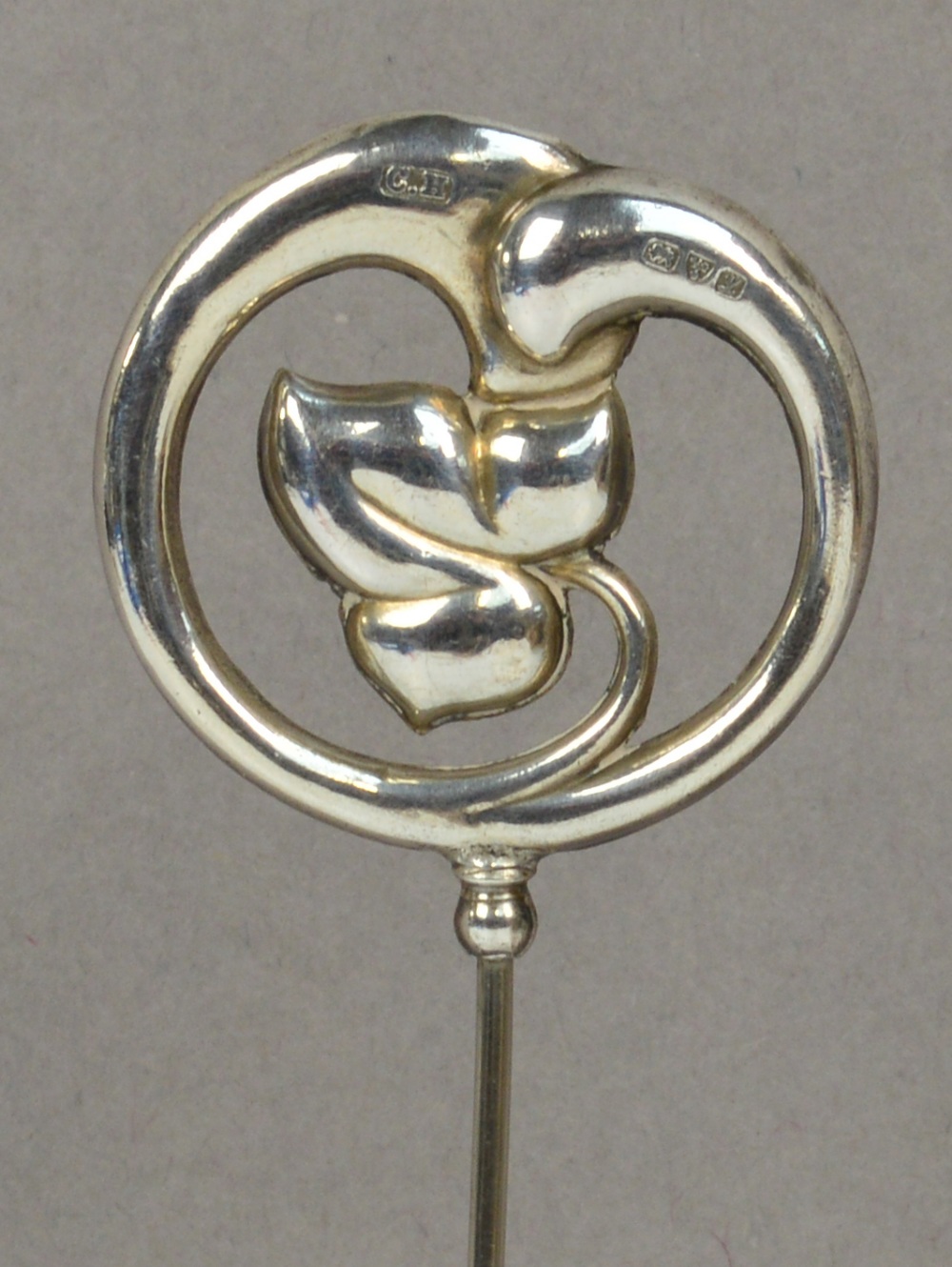 A Charles Horner hallmarked silver hat pin in the form of an ivy leaf within a circular organic