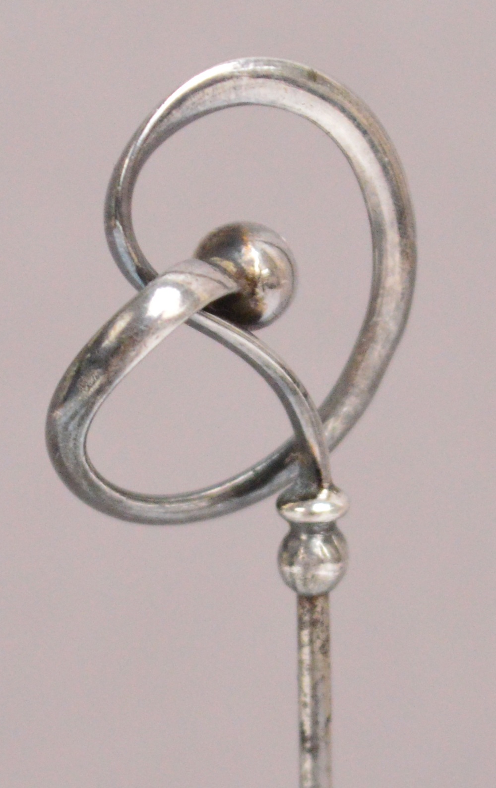 A Charles Horner hallmarked silver hat pin of abstract looping form with hollow ball, Chester 1909, - Image 2 of 2