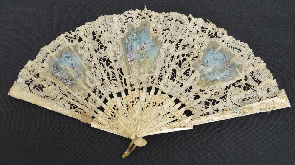 A 19th century European folding fan with pierced carved and gilt heightened guards with floral