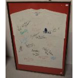 A tee shirt signed by members of 'The Bill', 95 x 67cm, framed and glazed.