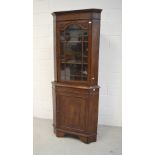 An early 20th century oak freestanding full length corner cupboard,