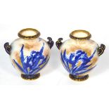 A pair of Royal Doulton blue and white floral decorated twin handled vases with gilt detailing,