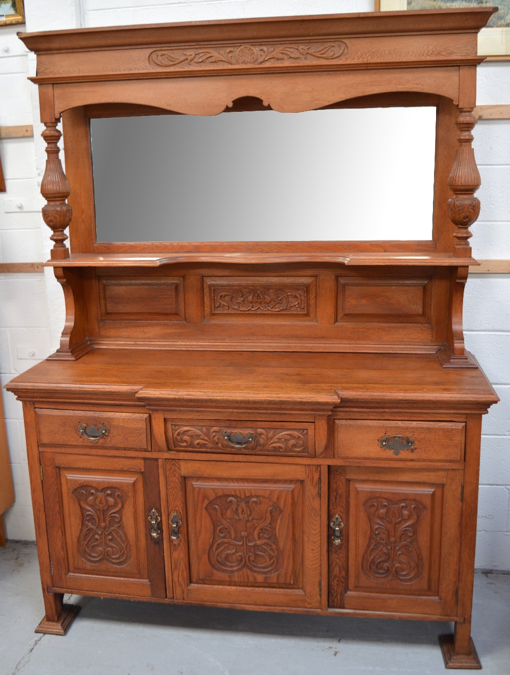 A large light oak sideboard,