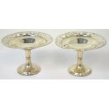 A pair of George V hallmarked silver shallow bowls with pierced rim on pedestal base,