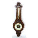 An oak wall barometer with carved floral decoration, height 57cm.