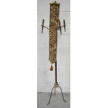 A modern metal and brass ecclesiastical style three branch standard lamp with tapestry decoration,