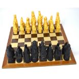 A cased chess set to include wooden board with composite figural chess pieces.