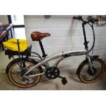 A Hopper Urban S.E. folding power assisted bicycle with silver frame.