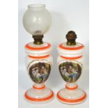 A pair of early 20th century baluster glass oil lamps,