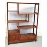 A Chinese hardwood display stand with an arrangement of stepped shelves,