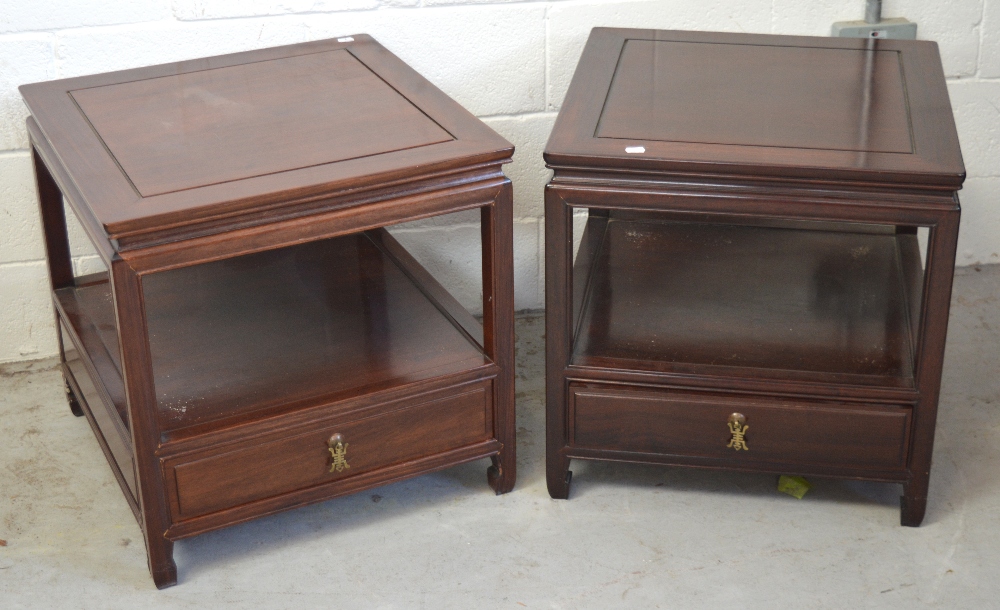 A pair of Chinese hardwood single drawer, two-tier bedside tables, width 56cm.