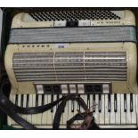 A cased Hohner Carmen IIIM piano accordion.