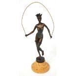 A hot cast bronze on a marble base of an Art Deco style exotic female dancer with skipping rope,