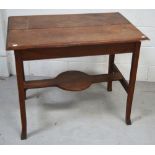 A mahogany side table with lower shaped shelf on curving legs, diameter 90cm.