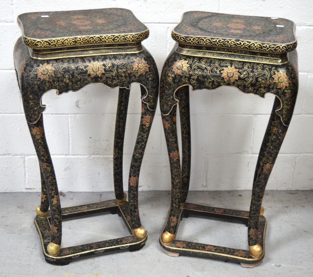 A pair of 20th century Oriental lacquered palm stands, curving legs with paw feet on a square stand,
