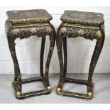 A pair of 20th century Oriental lacquered palm stands, curving legs with paw feet on a square stand,