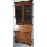 A c1900 walnut and inlaid bookcase bureau with twin astragal glazed doors to bracket feet,