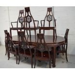 A Chinese hardwood dining suite comprising extending table with one extra leaf and a set of eight