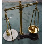 A large pair of brass W & T Avery Ltd of Birmingham scales on wooden base with accompanying weights.