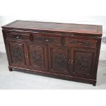 A Chinese hardwood sideboard, with three drawers above four doors carved with dragons, width 150cm.