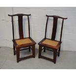A pair of Chinese hardwood altar chairs with rattan seats.