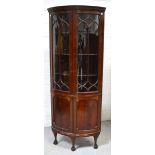 A mahogany bow front display cabinet,