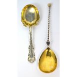 Two silver serving spoons, one example with twisted stem and gilt metal bowl,