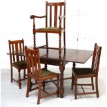 A mid 20th century oak dining table on wrythen supports and three matching dining chairs and one