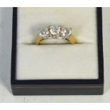A ladies' 9ct gold dress ring set with three graduating white stones, size M, approx 3.9g.