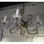 A six branch gilt metal and cut glass chandelier, height approx 75cm.