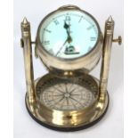 A contemporary chromed decorative combination table ship's clock/compass.