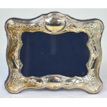 A silver repoussé photograph frame with midnight blue velvet backing, marked 925, 15 x 18cm.