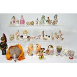 A quantity of miniature ceramics to include pincushion heads, figures of animals etc.