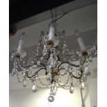 A six branch gilt metal and cut glass chandelier, height approx 55cm.