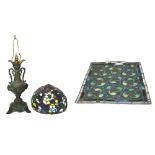 An ornate metal lamp with Tiffany style glass shade and a vintage Art Nouveau style stained glass