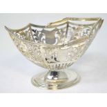 An Edward VII hallmarked silver swing handle hexagonal shaped basket with pierced sides and shield