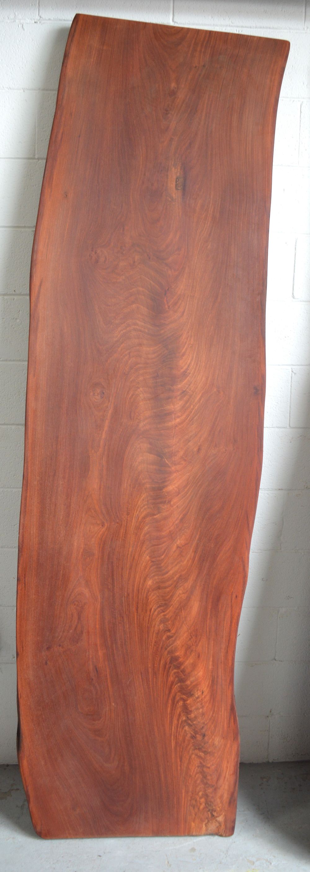 A well finished naturalistic hardwood dining table top, 260 x 65cm.